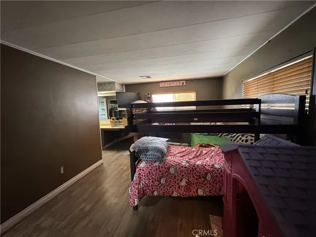 a bed sitting in a bedroom next to a window