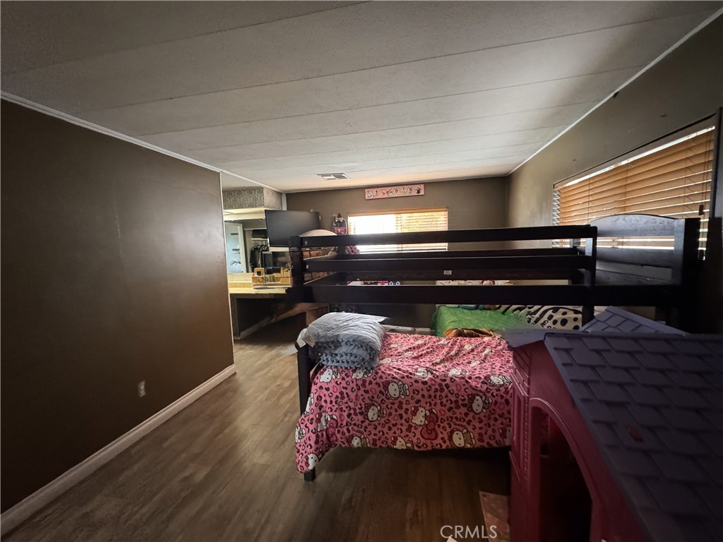 1025 South Riverside Avenue, Unit 66 Rialto, CA 92376 - Photo 29 of 53 a bed sitting in a bedroom next to a window