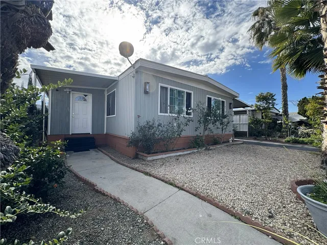 a view of a house with a yard and plants