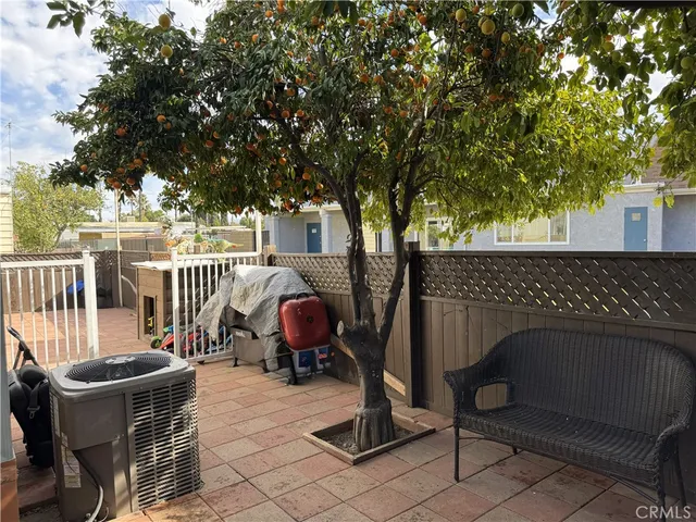 a backyard of a house with table and chairs