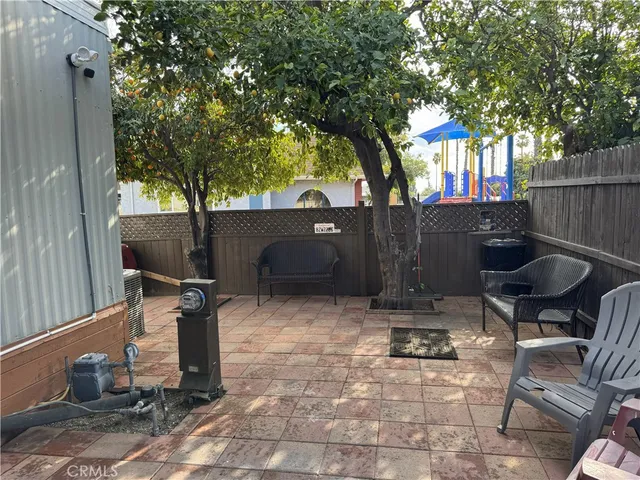 a backyard of a house with table and chairs