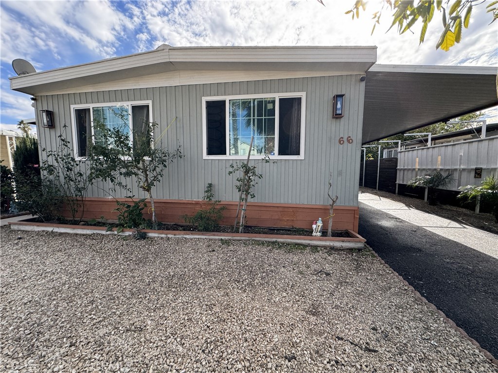 1025 South Riverside Avenue, Unit 66 Rialto, CA 92376 - Photo 4 of 53 a front view of a house with garden