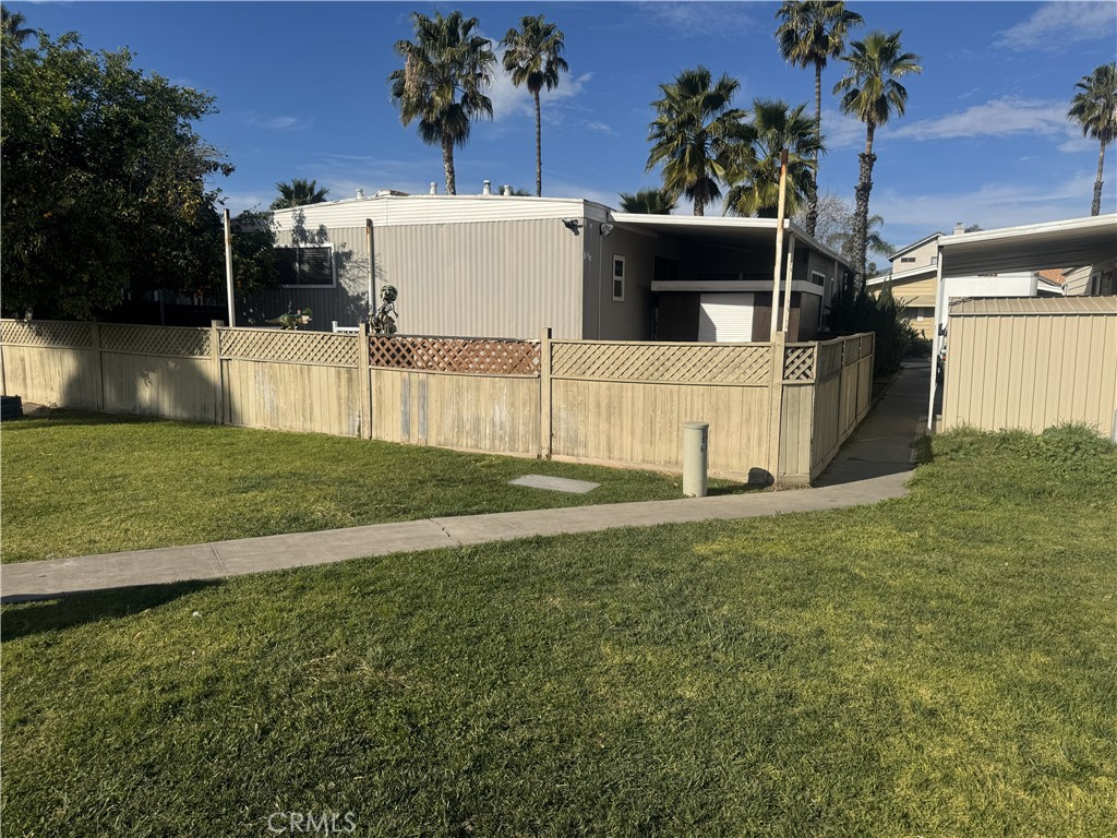 1025 South Riverside Avenue, Unit 66 Rialto, CA 92376 - Photo 49 of 53 a view of a house with a yard