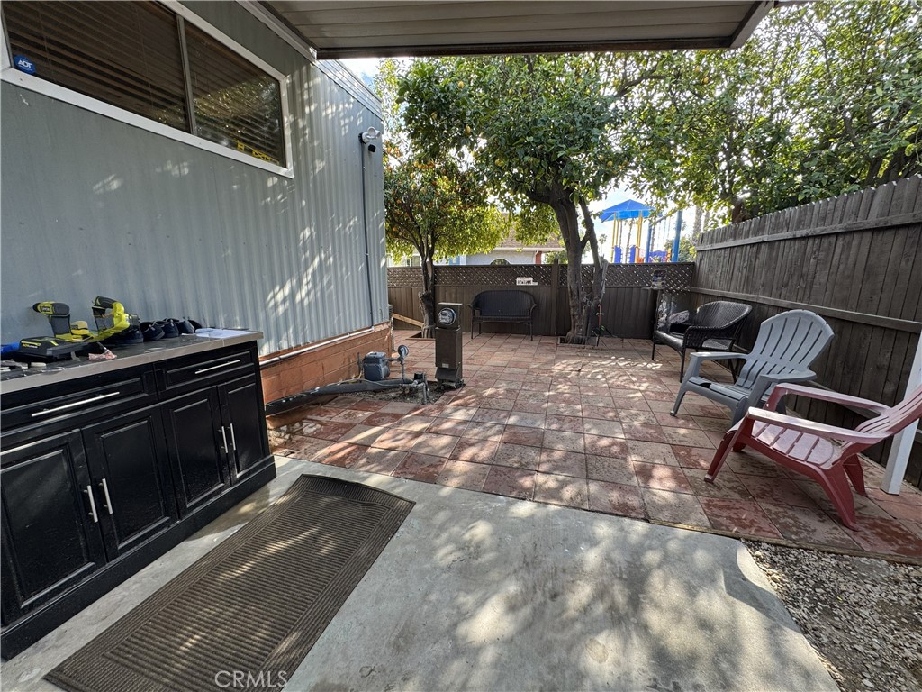 1025 South Riverside Avenue, Unit 66 Rialto, CA 92376 - Photo 6 of 53 a backyard of a house with table and chairs