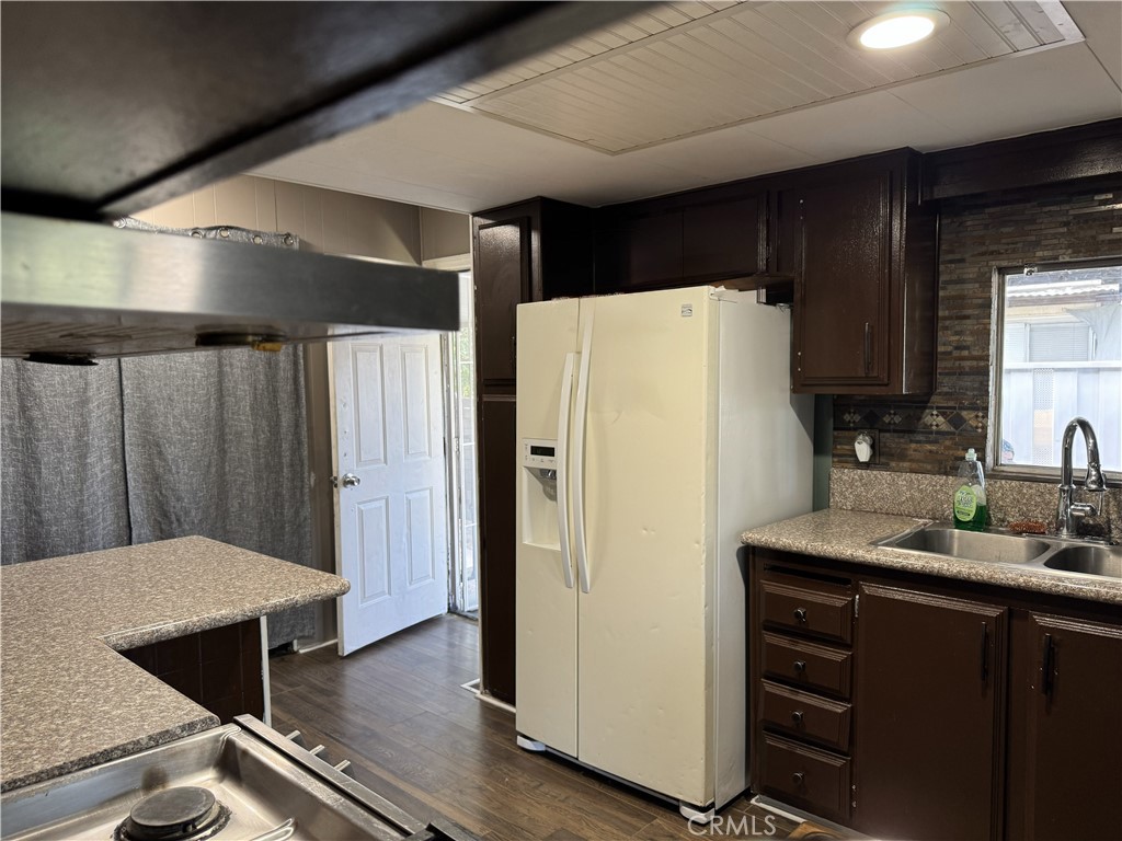 1025 South Riverside Avenue, Unit 66 Rialto, CA 92376 - Photo 8 of 53 a white refrigerator freezer sitting in a kitchen