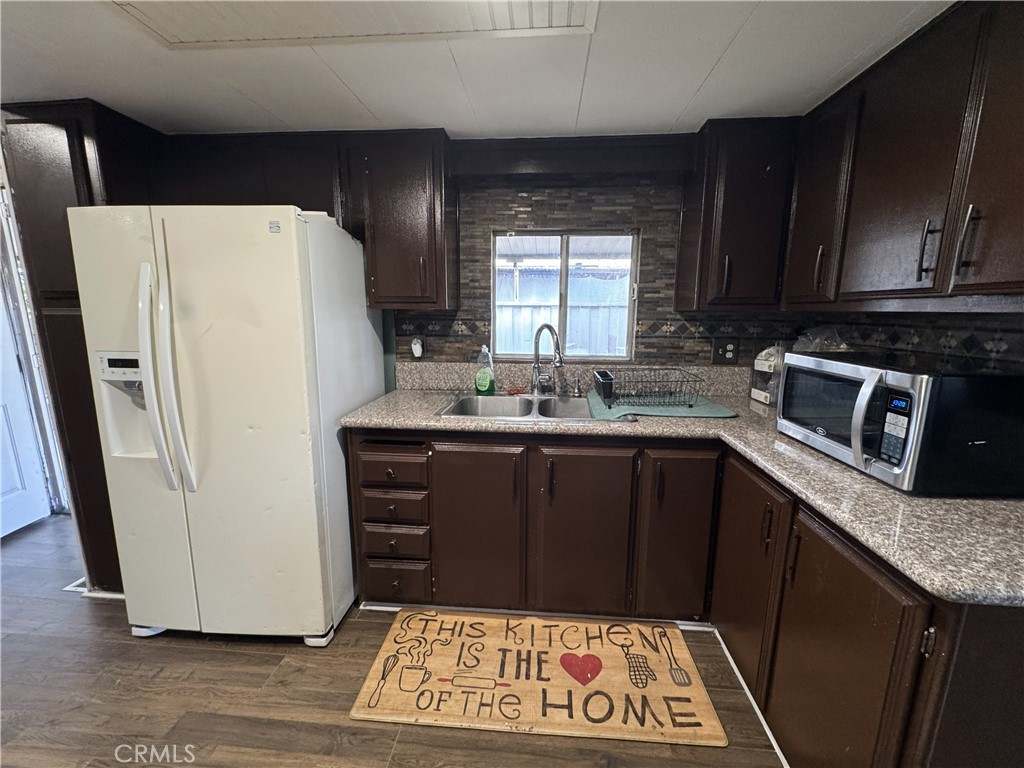 1025 South Riverside Avenue, Unit 66 Rialto, CA 92376 - Photo 9 of 53 a kitchen with a refrigerator sink and cabinets