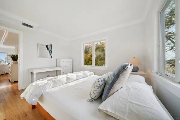 a bedroom with a bed and window