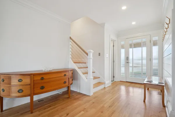 a large kitchen with cabinets and wooden floor