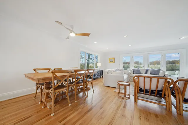 a living room with furniture fireplace and a large window