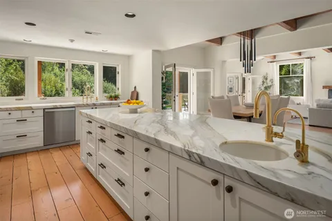 a kitchen with granite countertop a sink stove and cabinets