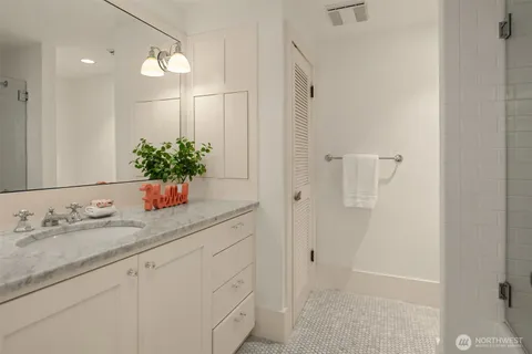 a bathroom with a granite countertop sink and a mirror