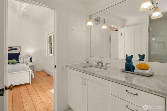 a bathroom with a sink double vanity granite and shower