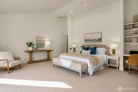 a spacious bedroom with a bed and a lamp