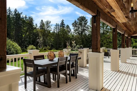 a view of a dining table and chairs in the roof deck