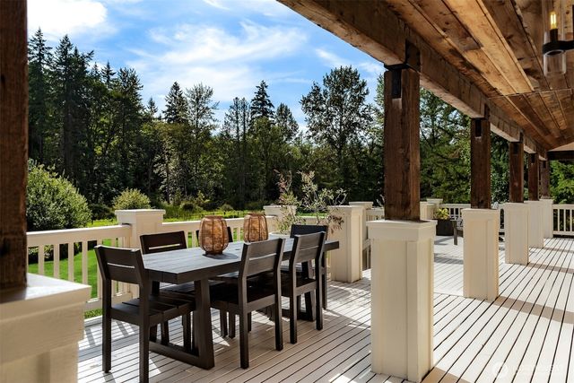 a view of a dining table and chairs in the roof deck