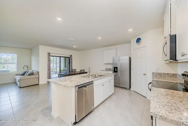 a view of a livingroom with furniture and a flat screen tv