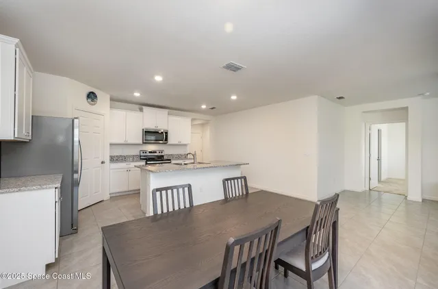 a bedroom with a bed and a ceiling fan