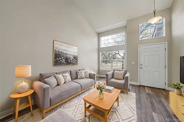 a living room with furniture and a wooden floor