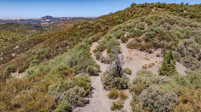 a view of a large building with mountains in the background