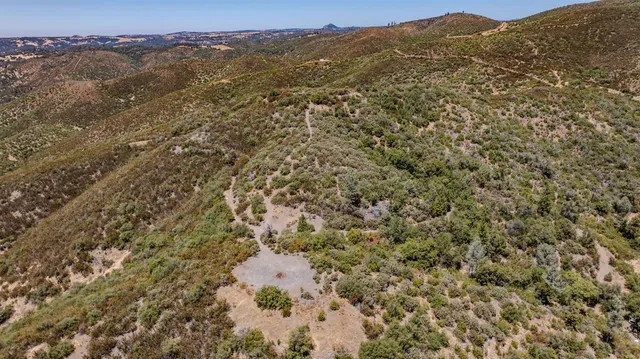 view of a mountain range with a lush green hillside
