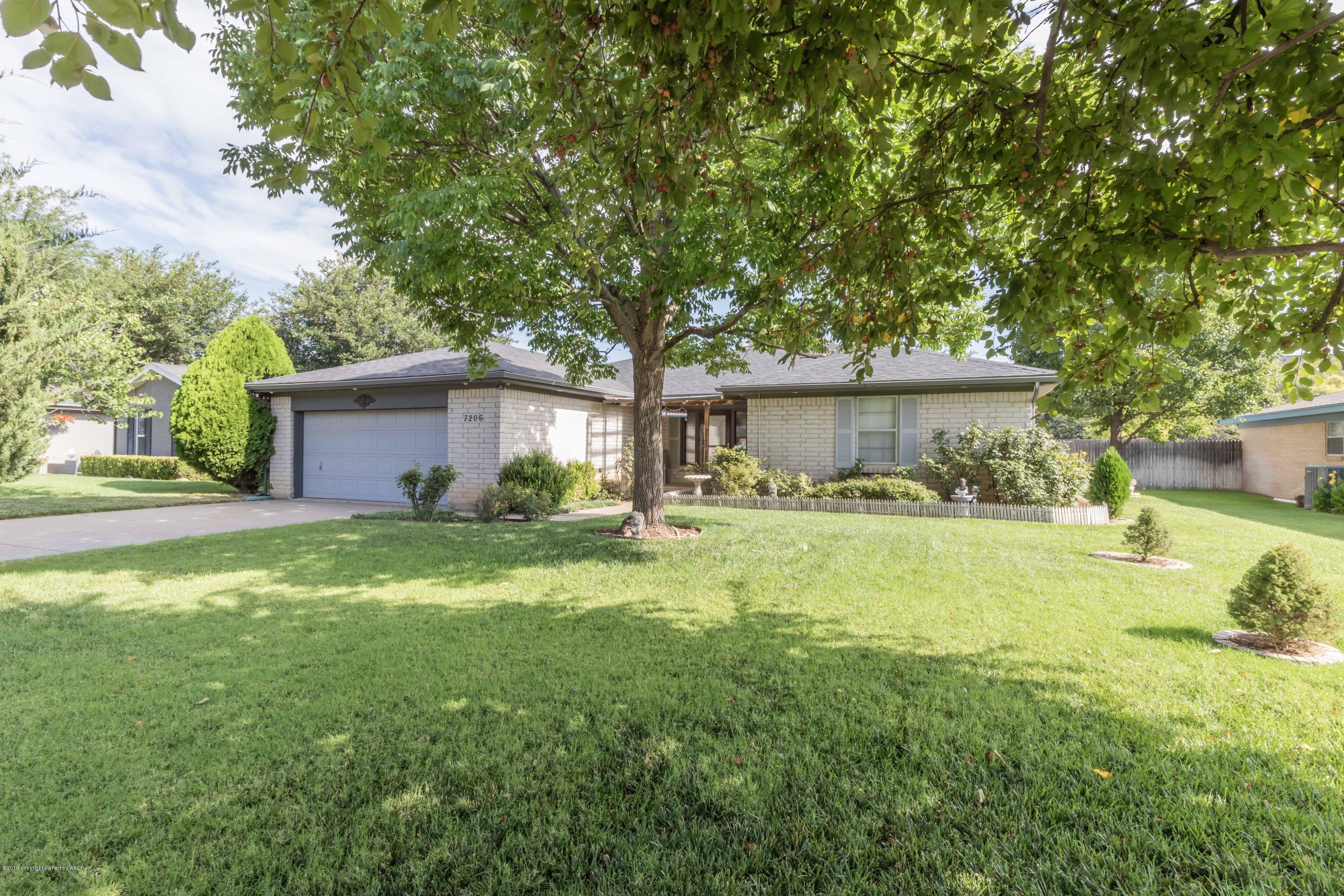 7206 Gainsborough Road Amarillo, TX 79106 - Photo 2 of 41 a front view of a house with a yard and a garage
