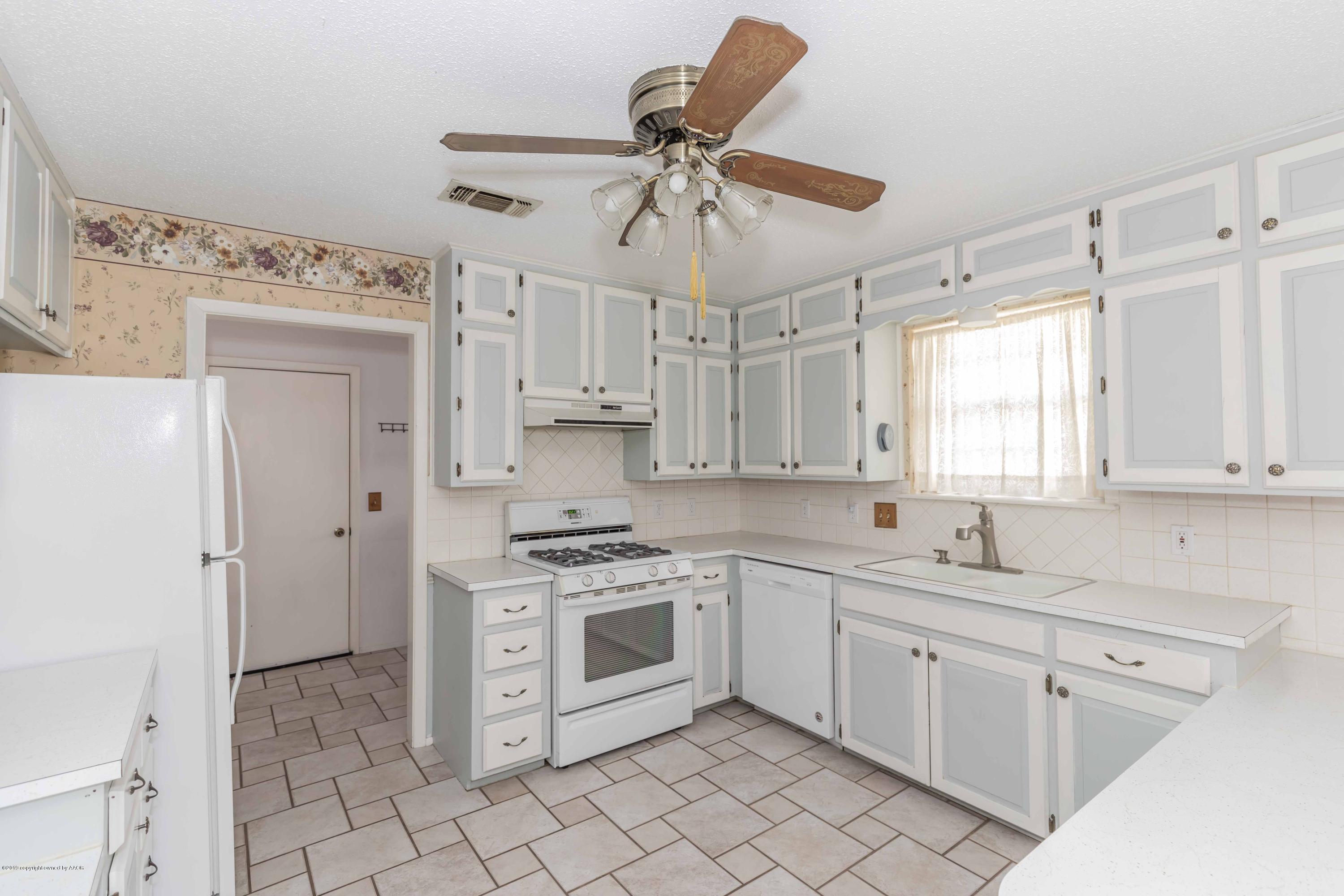 7206 Gainsborough Road Amarillo, TX 79106 - Photo 11 of 41 a kitchen with white cabinets and white appliances