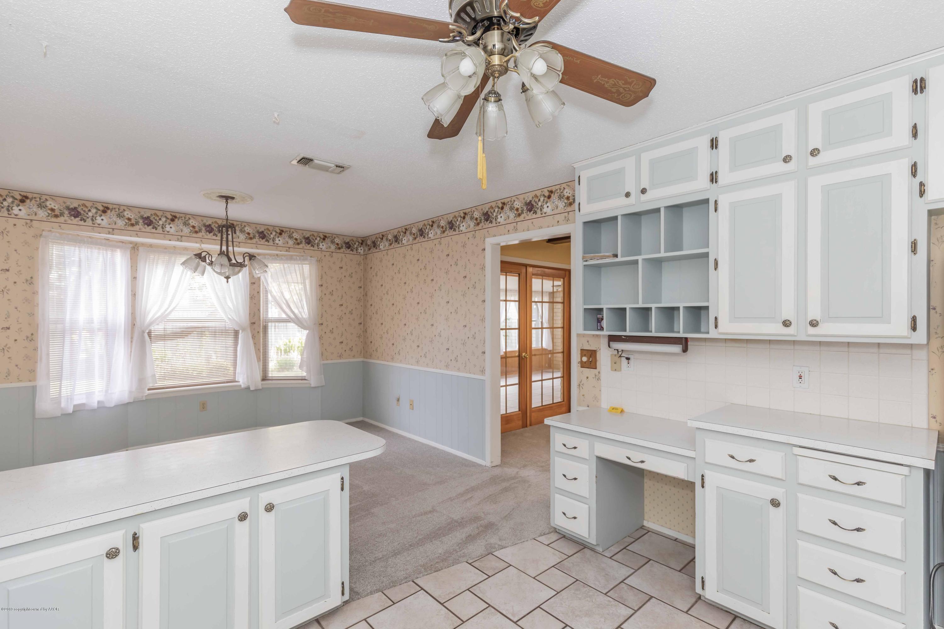 7206 Gainsborough Road Amarillo, TX 79106 - Photo 14 of 41 a kitchen with cabinets appliances and a window