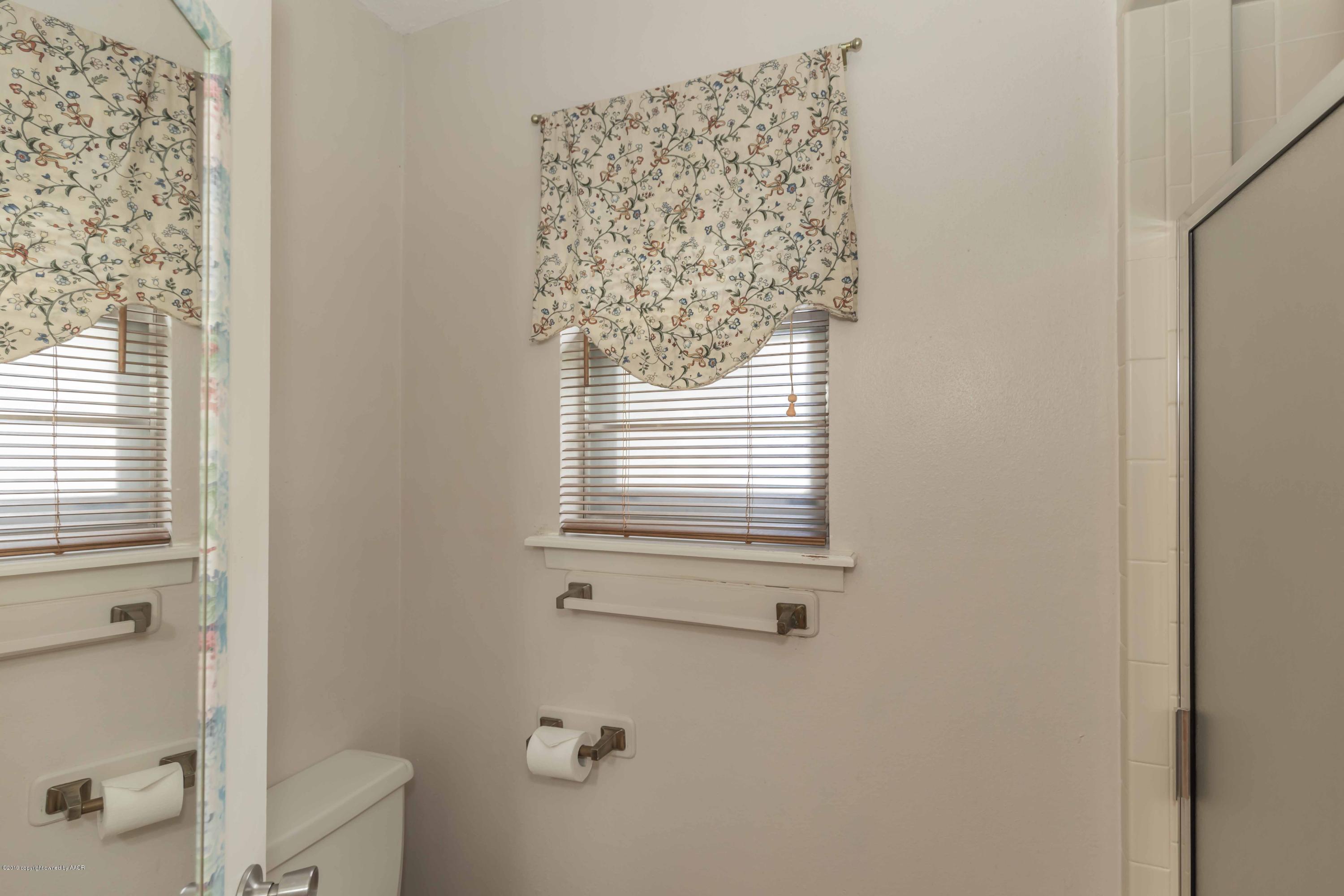 7206 Gainsborough Road Amarillo, TX 79106 - Photo 23 of 41 a bathroom with a window and a shower