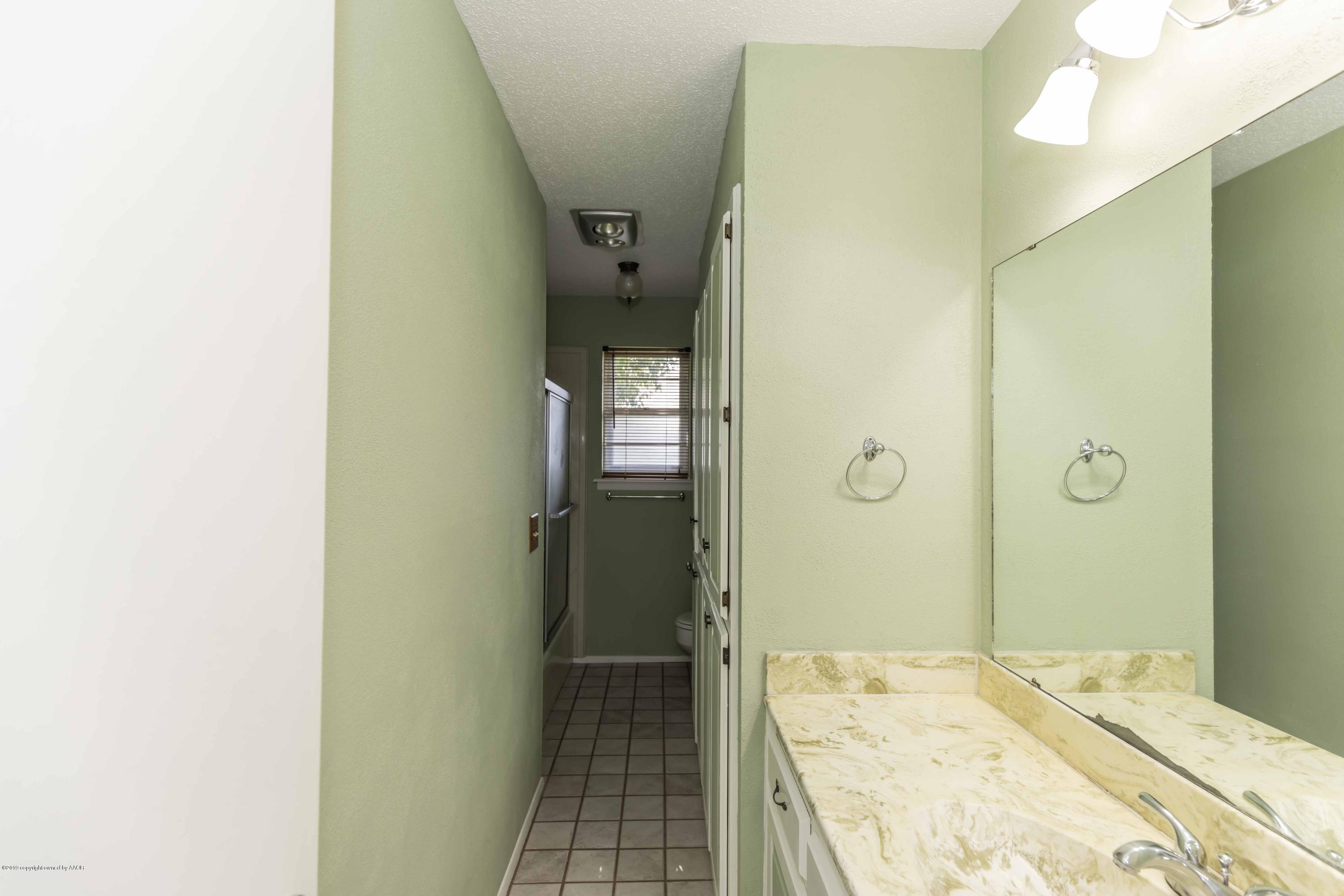 7206 Gainsborough Road Amarillo, TX 79106 - Photo 32 of 41 a bathroom with a sink and a shower