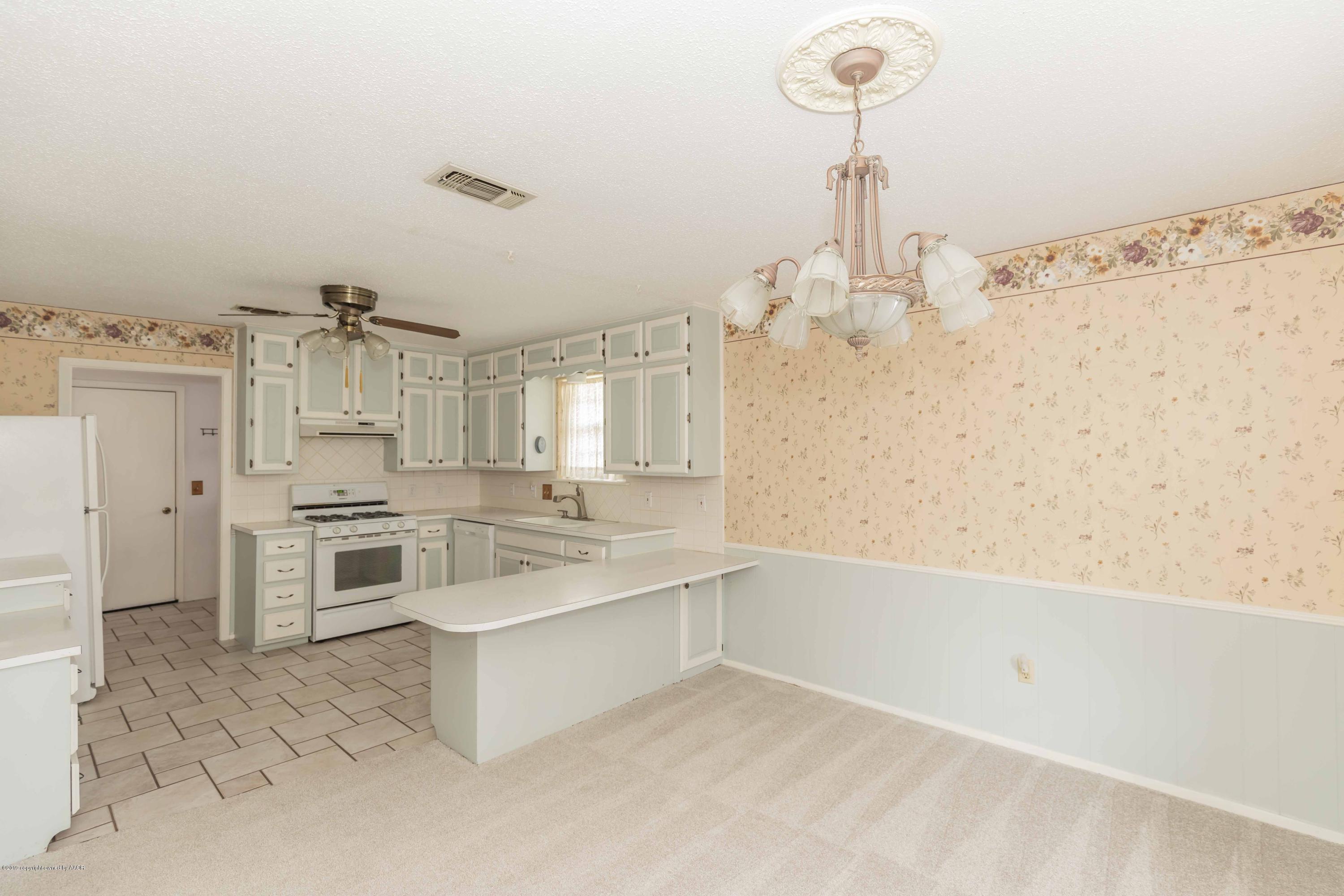 7206 Gainsborough Road Amarillo, TX 79106 - Photo 10 of 41 a large white kitchen with a stove and a sink