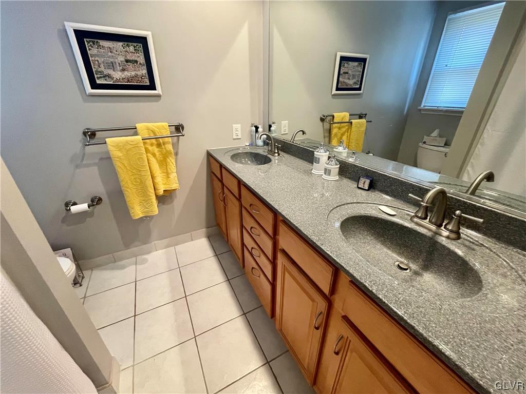 1295 Stark Road Bethlehem, PA 18017 - Photo 30 of 36 a bathroom with a granite countertop sink a mirror a vanity and a shower