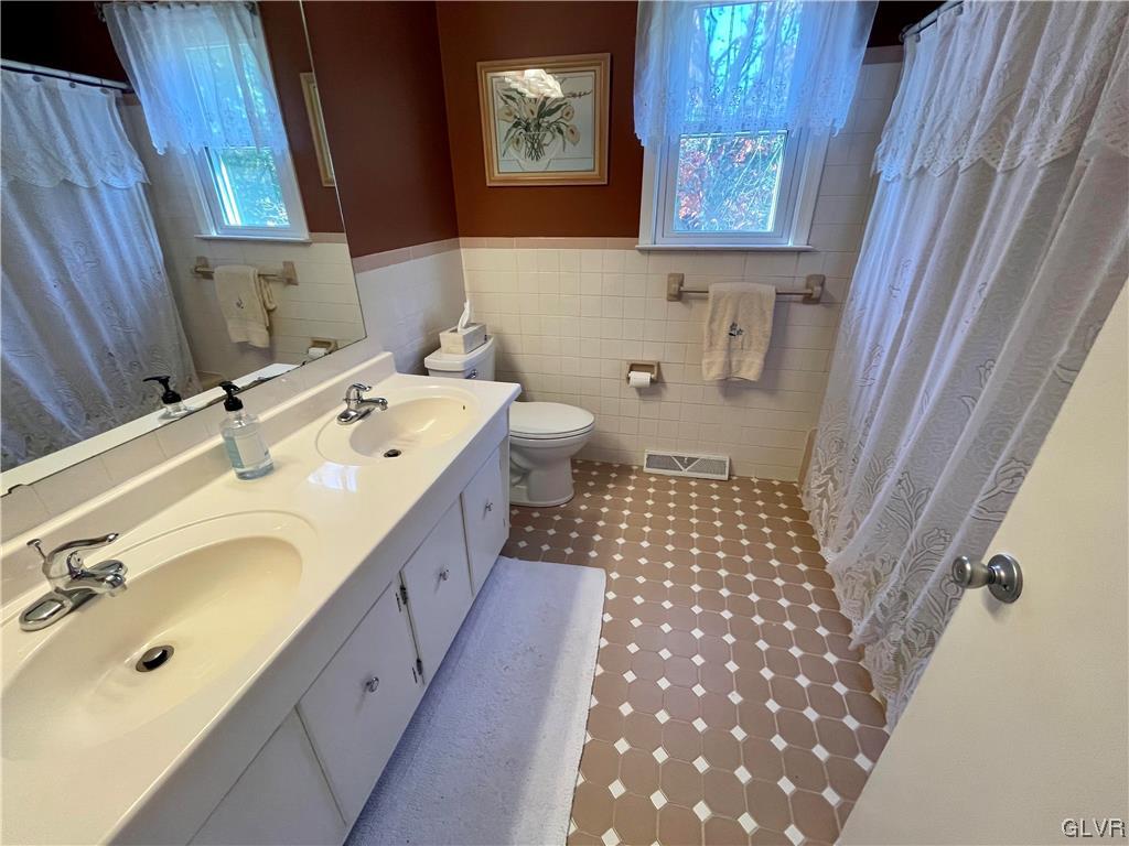 1295 Stark Road Bethlehem, PA 18017 - Photo 32 of 36 a bathroom with a double vanity sink mirror and toilet