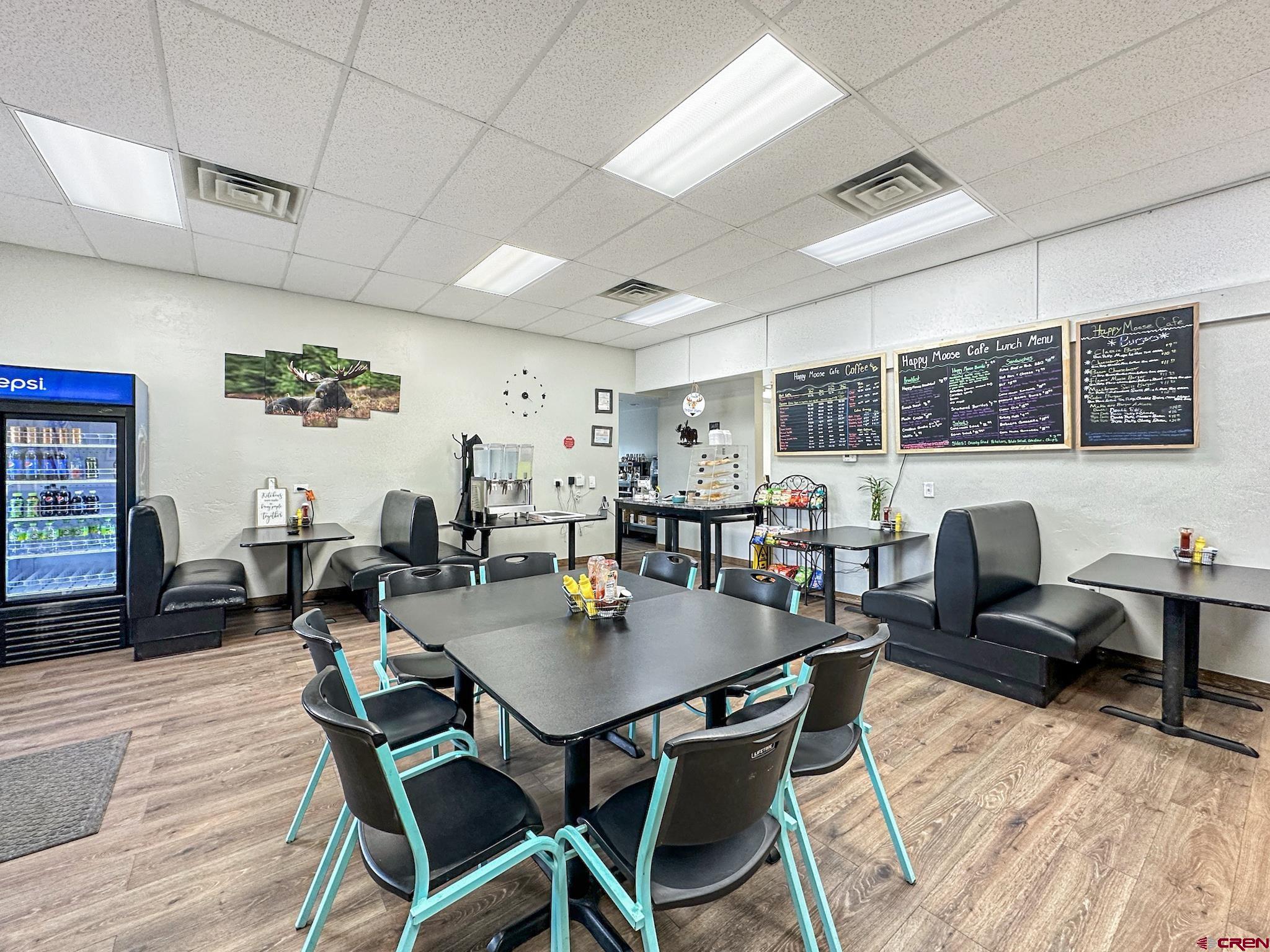 12840 Highway 65 Eckert, CO 81418 - Photo 16 of 34 a view of a dining room with furniture window and wooden floor
