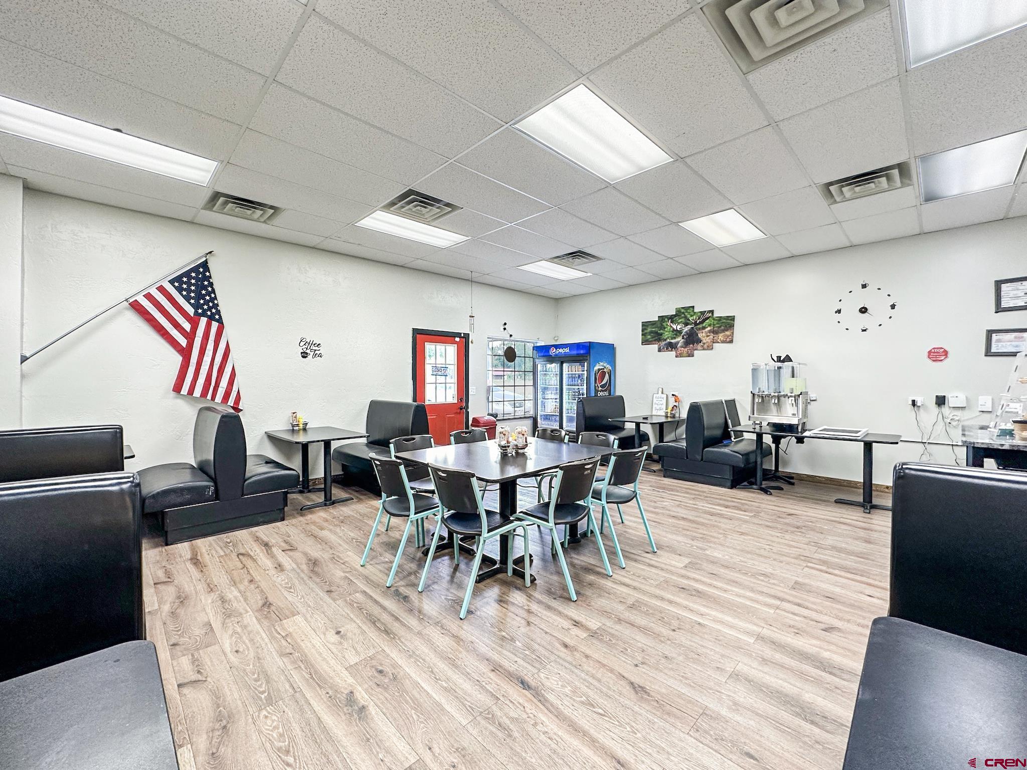 12840 Highway 65 Eckert, CO 81418 - Photo 4 of 34 a view of a dining room with furniture window and wooden floor