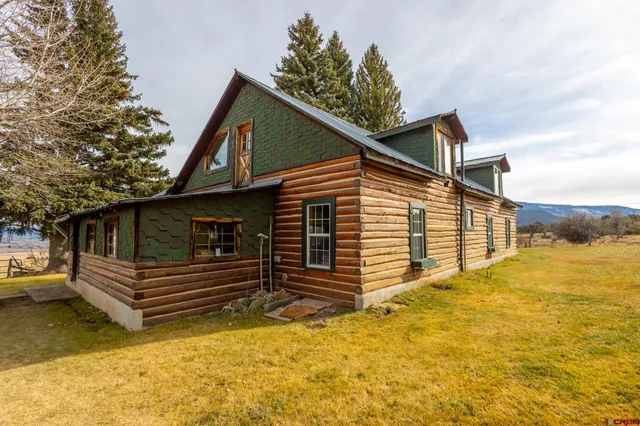 a view of house with backyard and wooden fence