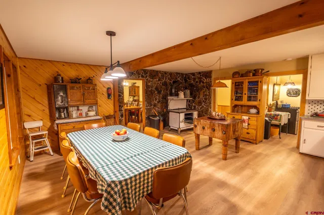 a dining room with furniture and wooden floor