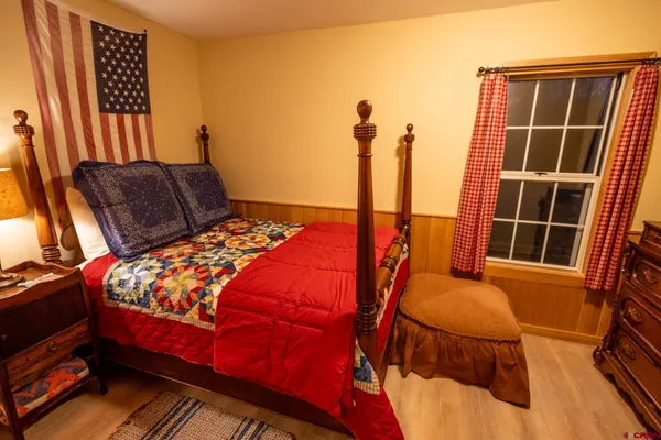 a bedroom with two beds and a potted plant