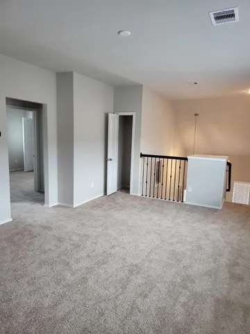 an empty room with windows and pillars in it