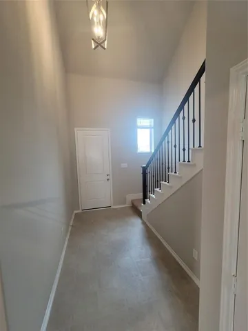 wooden floor in an empty room with a staircase