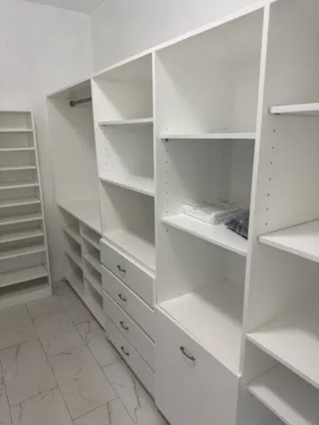 an empty room with windows and closet