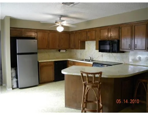 a kitchen with a table chairs refrigerator and cabinets