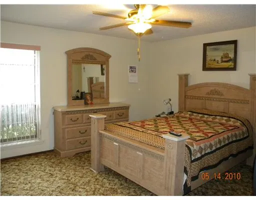 a bedroom with a bed and a dresser