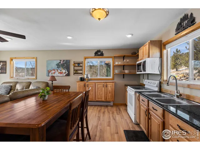 a kitchen with stainless steel appliances wooden floor and large counter top space