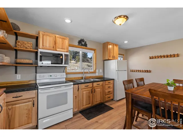 a kitchen with stainless steel appliances granite countertop a stove a sink dishwasher and cabinets