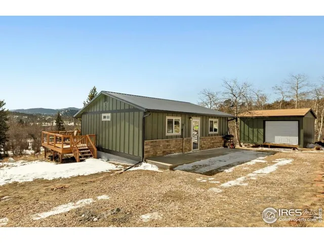 a view of a house with a patio and a yard