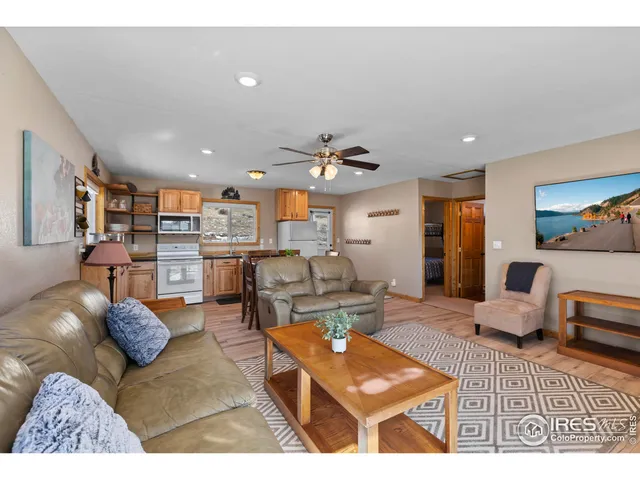 a living room with furniture kitchen view and a table