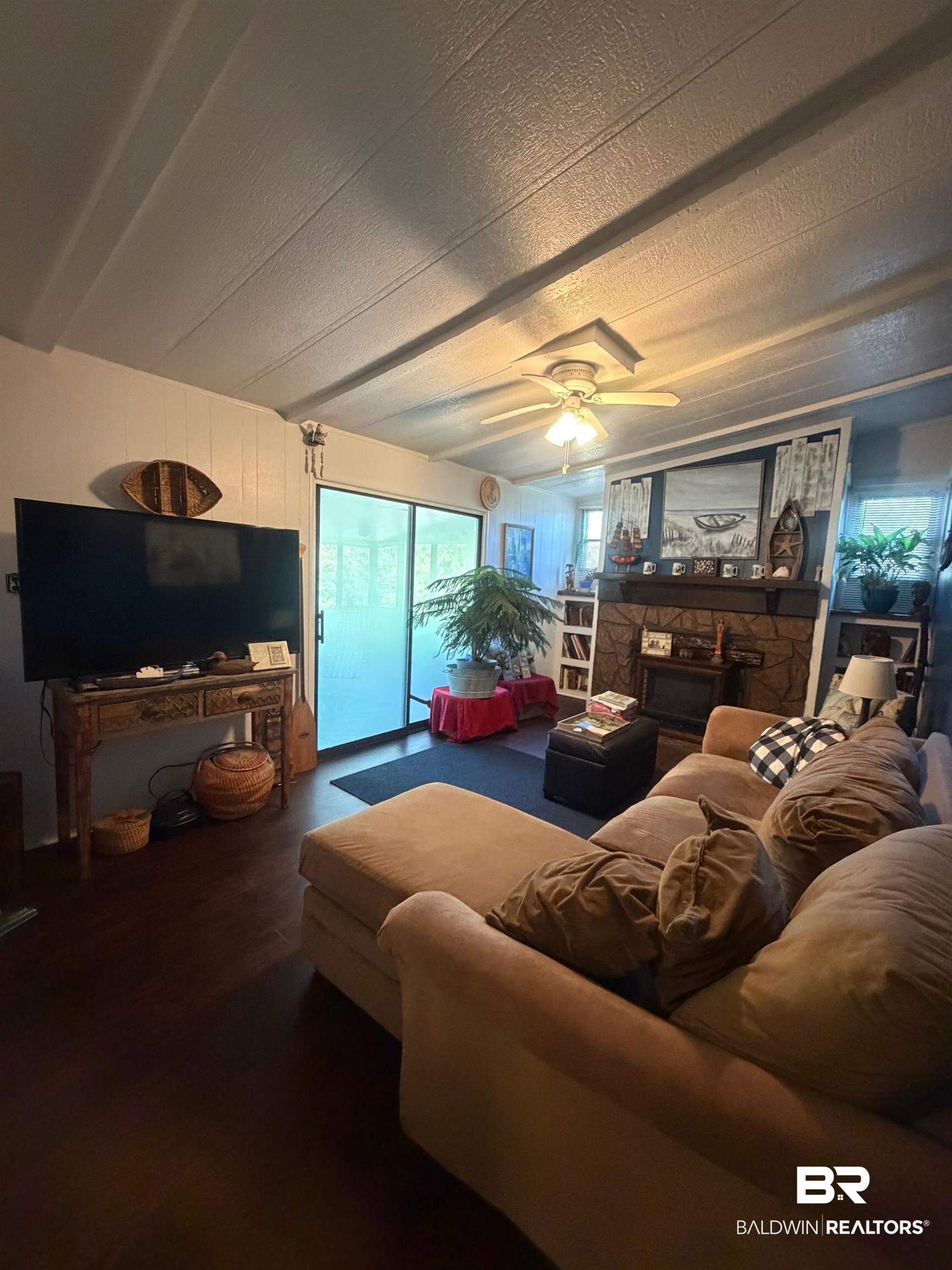 1430 Ridgewood Drive Lillian, AL 36549 - Photo 14 of 34 Living area with ceiling fan and a textured ceiling