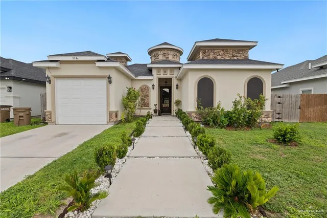 a front view of a house with garden