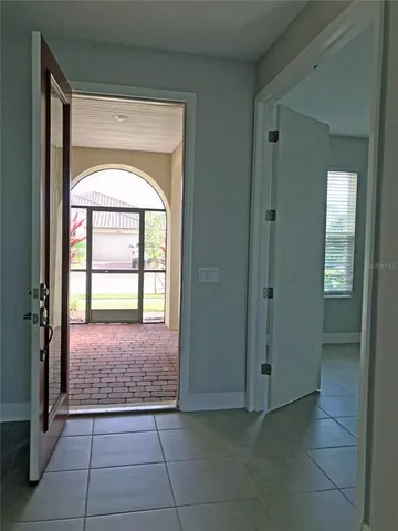 a view of a hallway with wooden floor and entryway