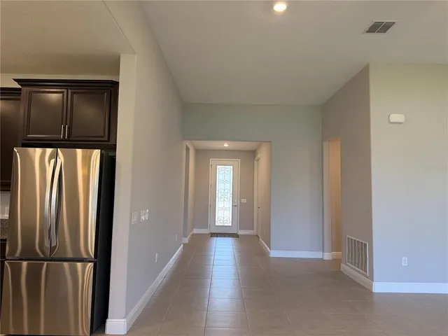 a kitchen with stainless steel appliances granite countertop a refrigerator a stove and a sink